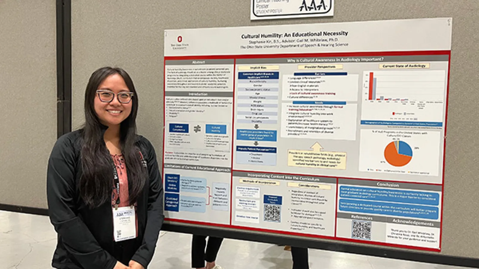 Stephanie Xin poses in front of research poster