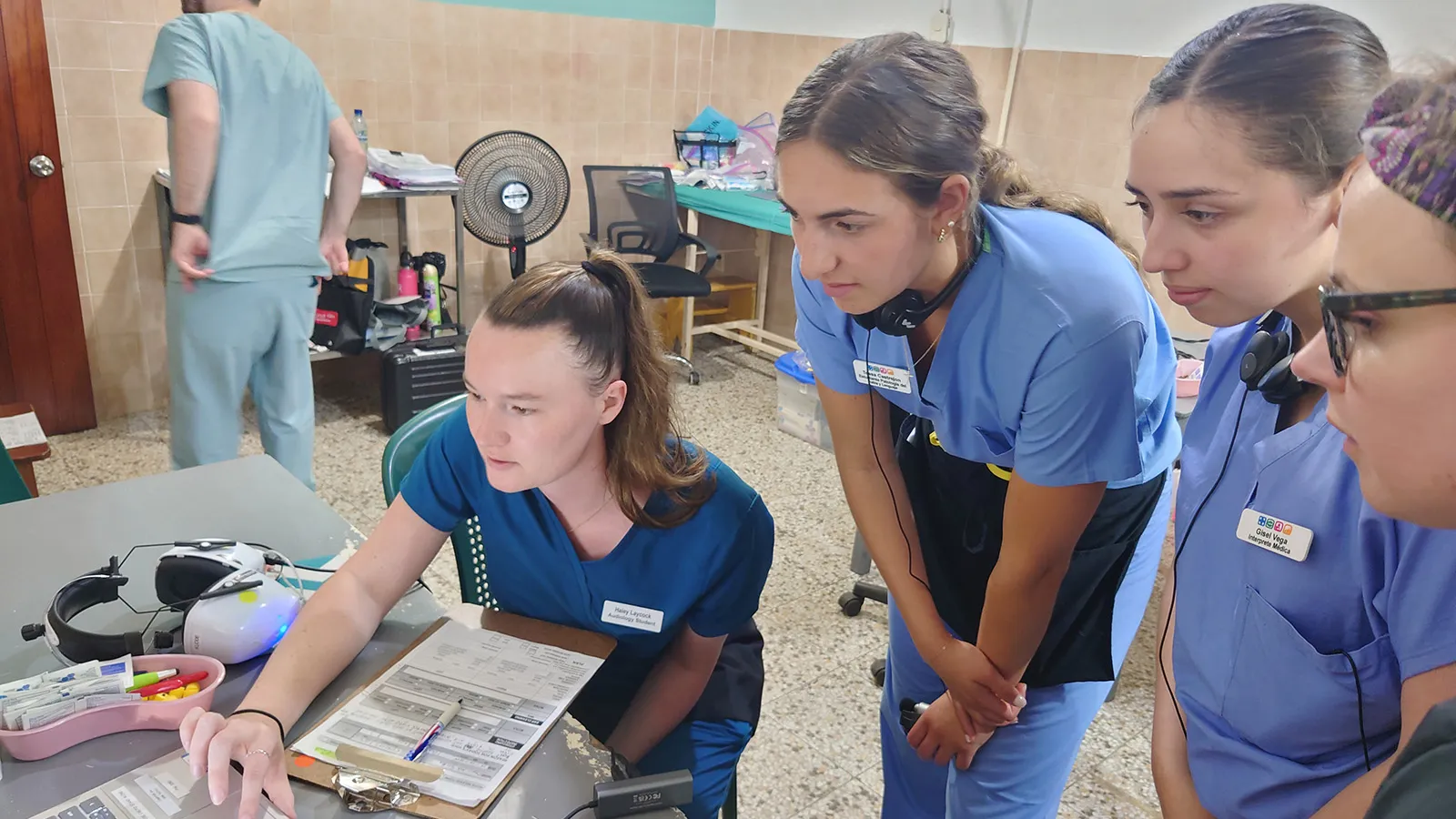 Students in scrubs in clinic