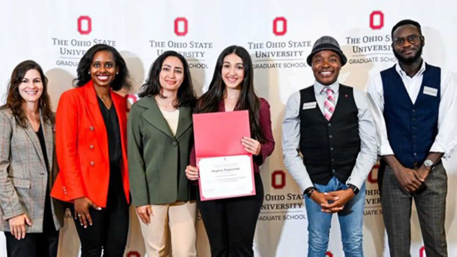 Group photo of student holding certificate